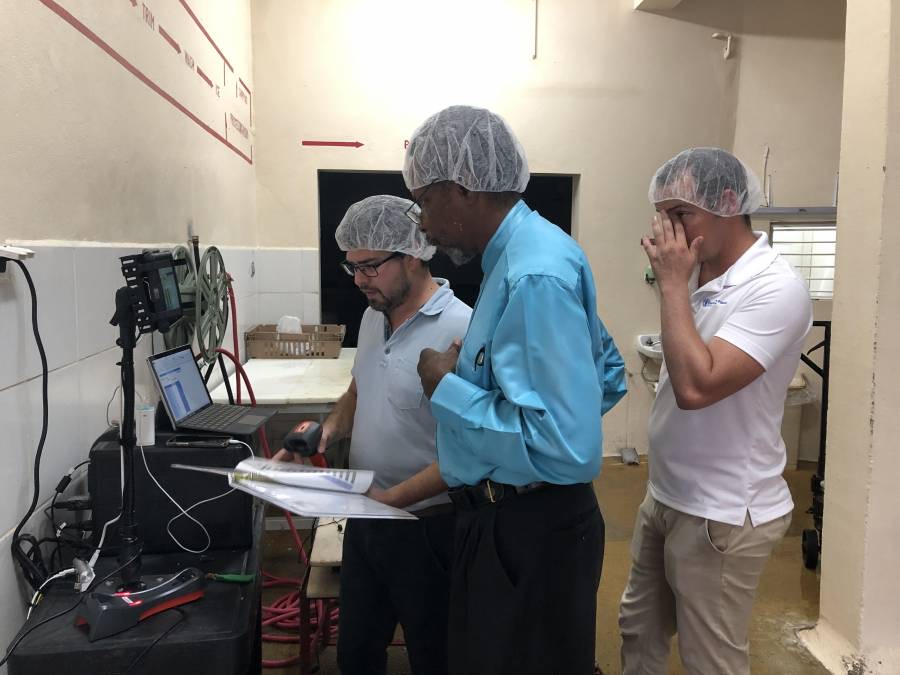 Team members reviewing data on a laptop inside the GNExTT processing facility